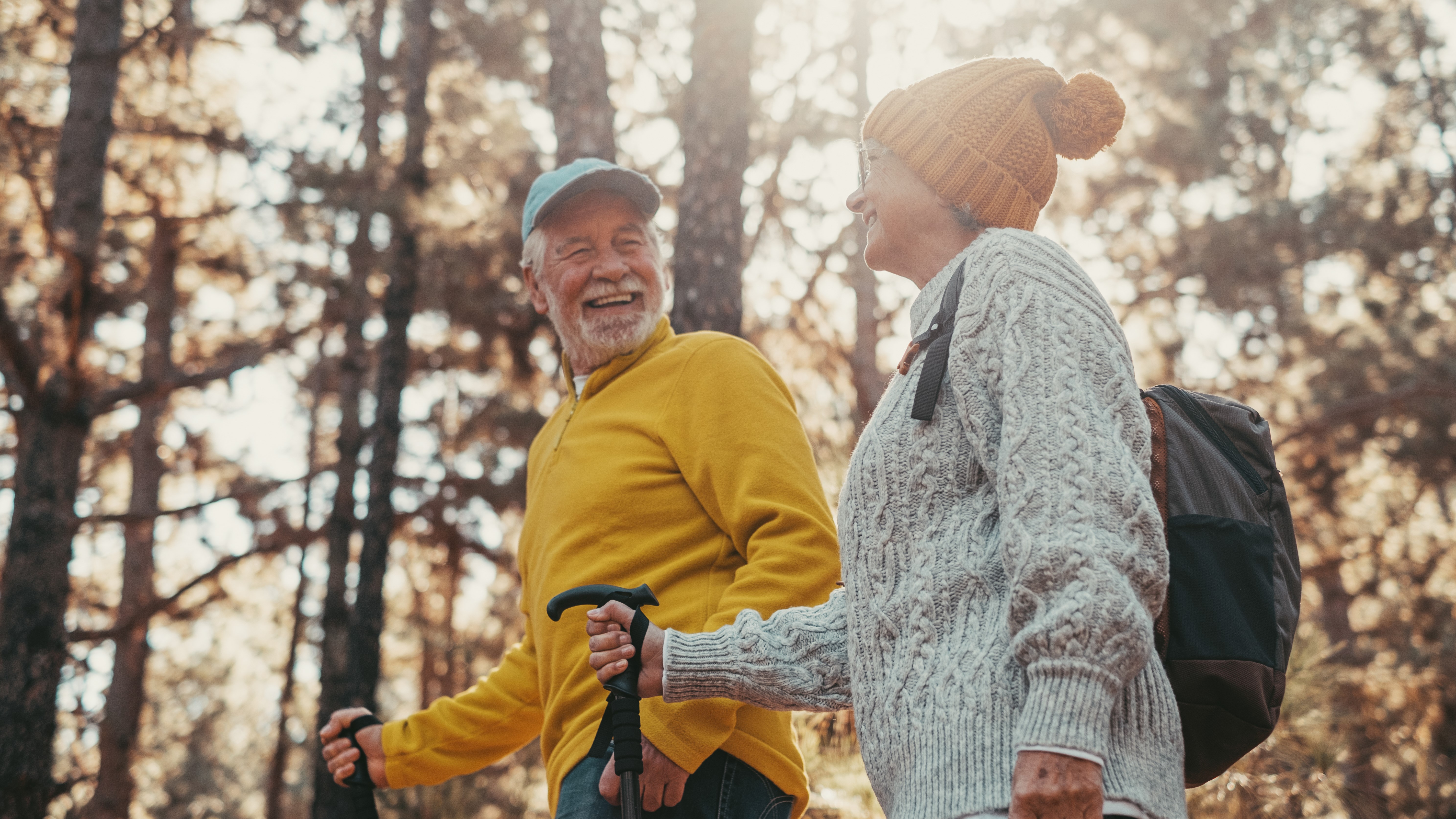 Portrait close up head shot of one cheerful smiling middle age woman walking with her husband enjoying free time and nature. Active beautiful seniors in love together at sunny day.